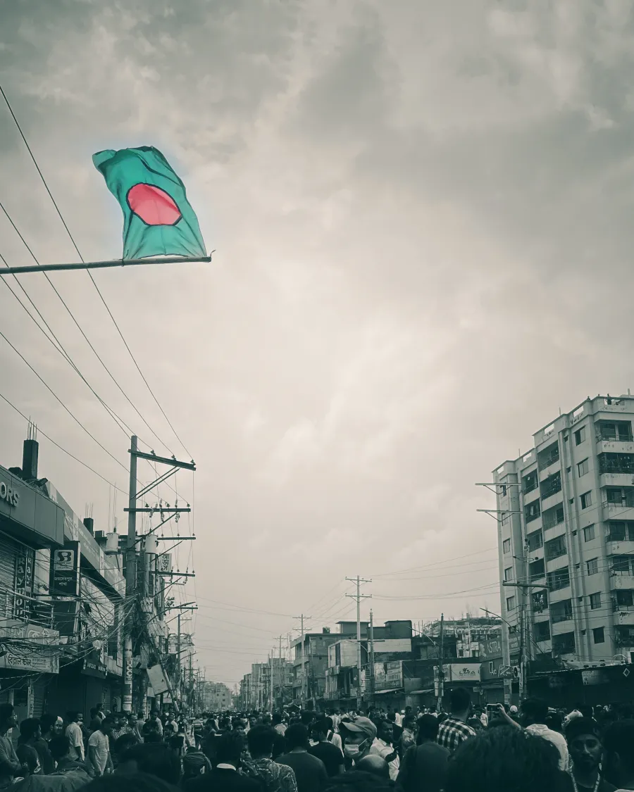 Bangladesh flag flying over a crowded street